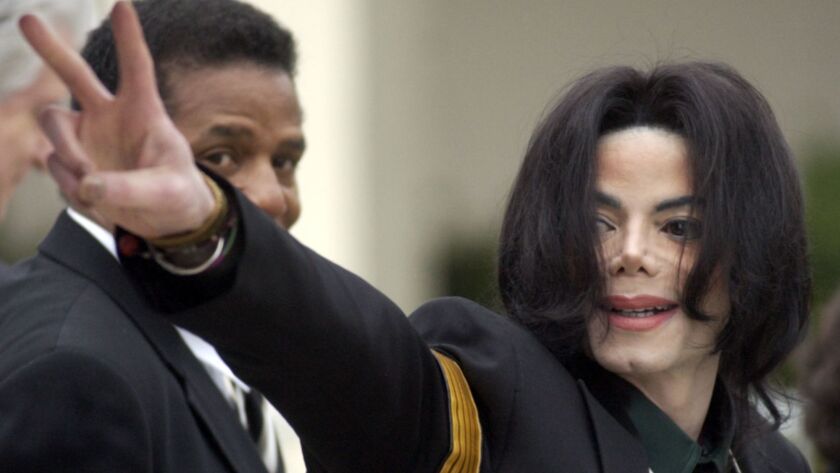 Michael Jackson waves to his supporters as he arrives for his child molestation trial at the Santa Barbara County Superior Court in Santa Maria, Calif., in 2005.