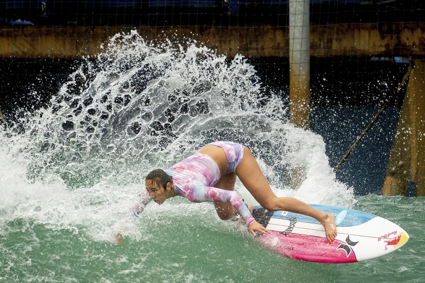 Carissa Moore of the United States, practices for a World Surf League competition at Surf Ranch on Wednesday, June 16, 2021, in Lemoore, Calif. The Summer Games in Tokyo, which kick off this month, serve as a proxy for that unresolved tension and resentment, according to the Native Hawaiians who lament that surfing and their identity have been culturally appropriated by white outsiders who now stand to benefit the most from the $10 billion industry. (AP Photo/Noah Berger)