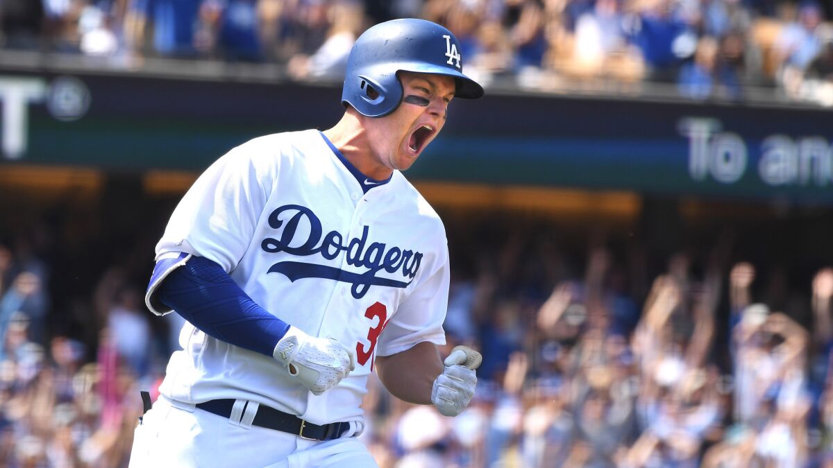 Dodgers outfielder Joc Pederson celebrates after hitting a grand slam against the Padres on opening day at Dodger Stadium.