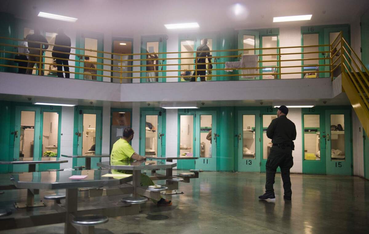 TOPSHOT - A sheriff's deputy (R) talks to an immigration detainee (L) in a high security housing unit at the Theo Lacy Facility, a county jail which also houses immigration detainees arrested by the US Immigration and Customs Enforcement (ICE), March 14, 2017 in Orange, California, about 32 miles (52km) southeast of Los Angeles. US President Donald Trumps first budget provides more than USD 4.5 billion in new spending to fight illegal immigration by adding immigration and border enforcement agents, prosecutors and judges, as well as building a wall on the border with Mexico. / AFP PHOTO / Robyn BeckROBYN BECK/AFP/Getty Images ** OUTS - ELSENT, FPG, CM - OUTS * NM, PH, VA if sourced by CT, LA or MoD **