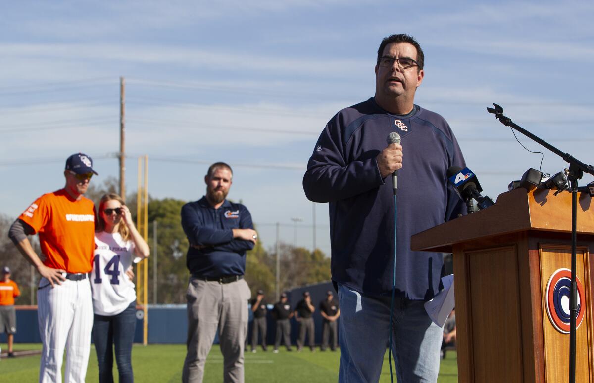 Tony Altobelli, Orange Coast College's sports information director, speaks during a tribute for his brother, John Altobelli, before Tuesday's game against Southwestern. Behind, from left, acting head coach Nate Johnson with his wife, Jonai, and athletic director Jason Kehler.