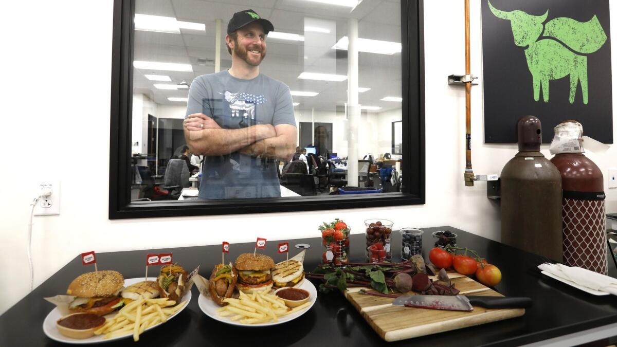 Ethan Brown, founder and CEO of Beyond Meat, stands behind some of their products at the company's headquarters in El Segundo.