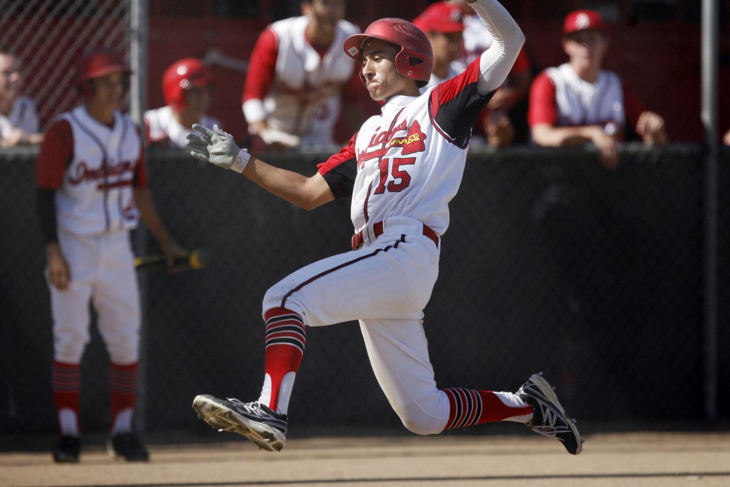 Burroughs' Akira Abderrahman slides to home plate and makes a run during a game against San Luis Obispo at John Burroughs High School in Burbank on Tuesday, May 14, 2013.