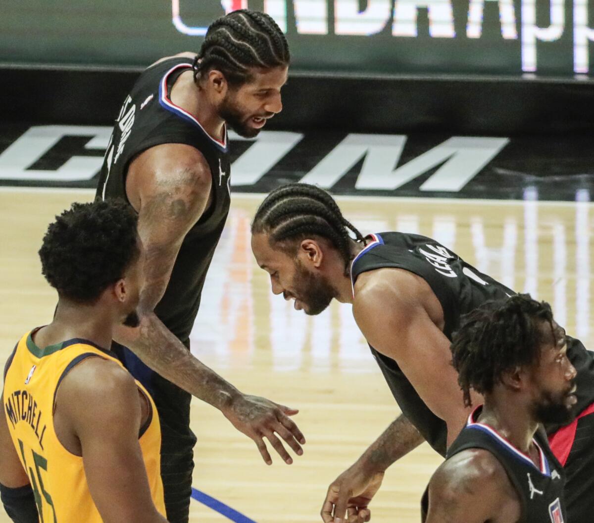 The Clippers' Kawhi Leonard is in pain as teammate Paul George checks on him during Game 4 against the Jazz.
