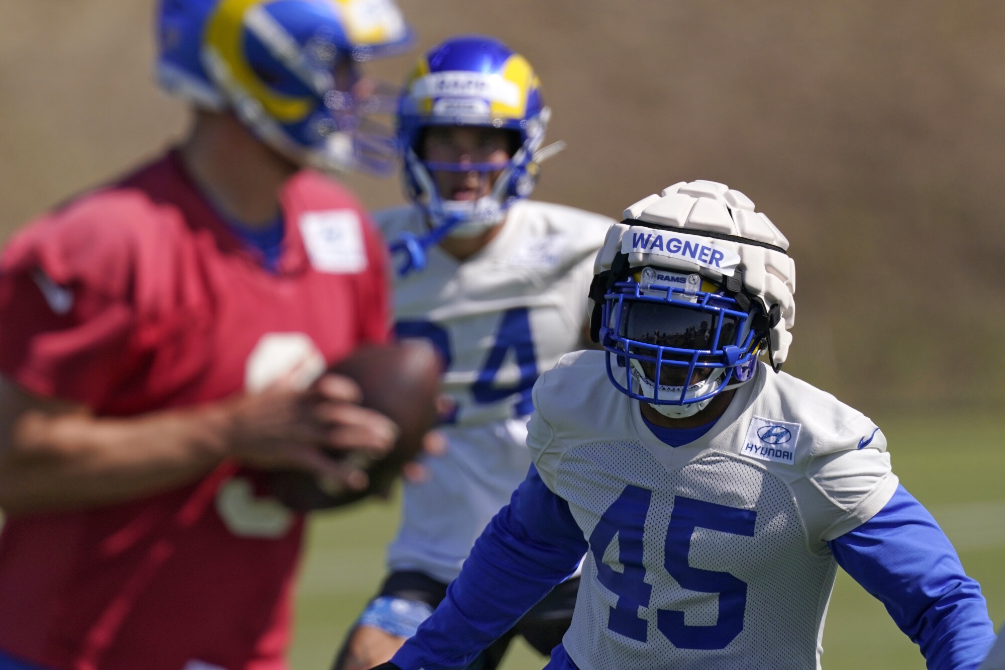 Rams linebacker Bobby Wagner (45) pursues Matthew Stafford during practice.