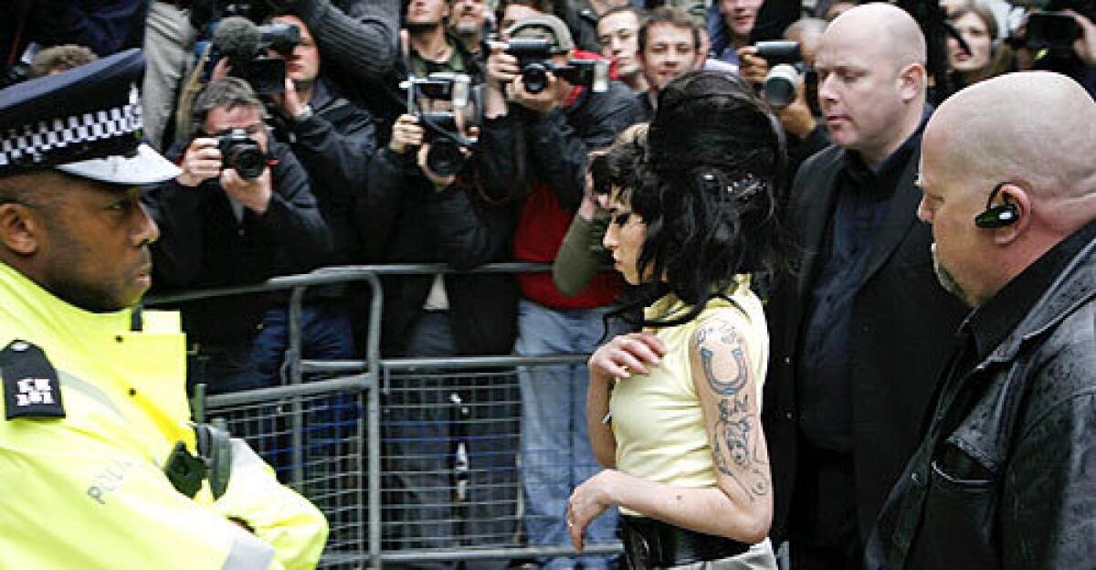 Amy Winehouse didn't say anything to assembled photographers and cameramen as she walked into the Holborn Police Station late Friday afternoon.