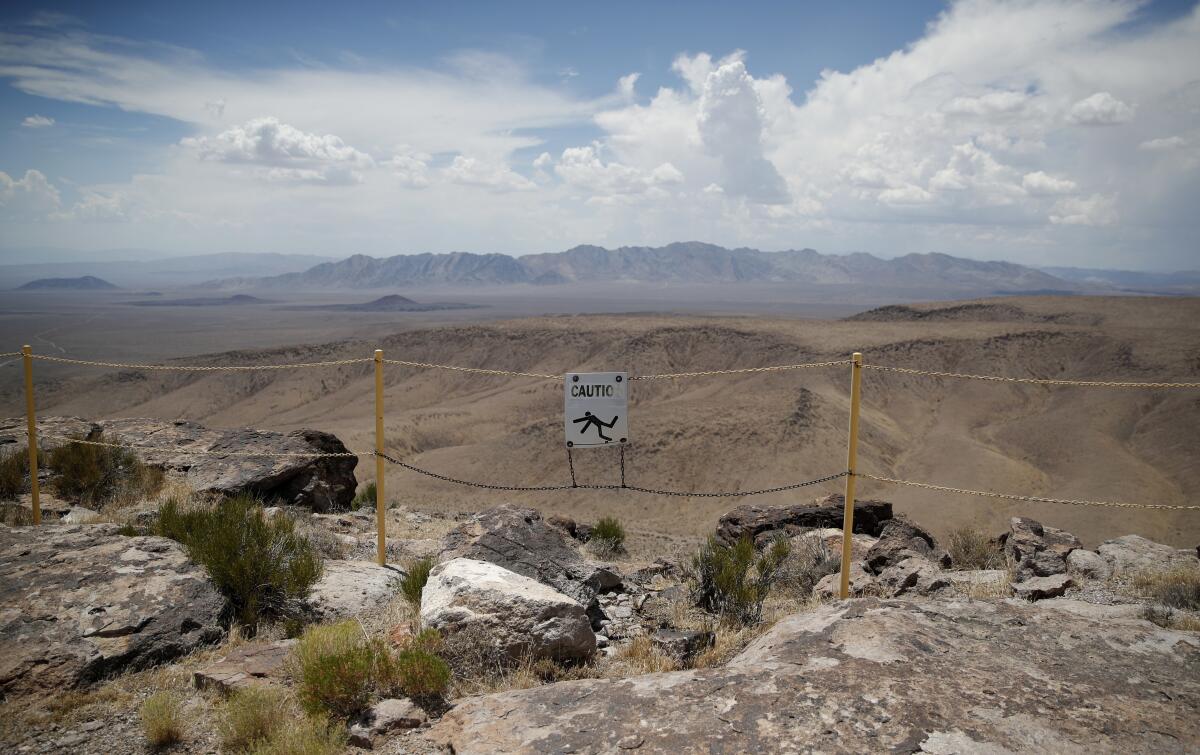 A sign warning of a falling hazard in a desert landscape