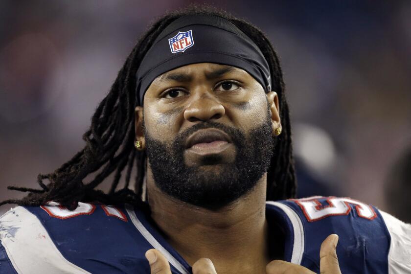 Brandon Spikes watches from the sideline during a New England Patriots game on Dec. 10, 2012.