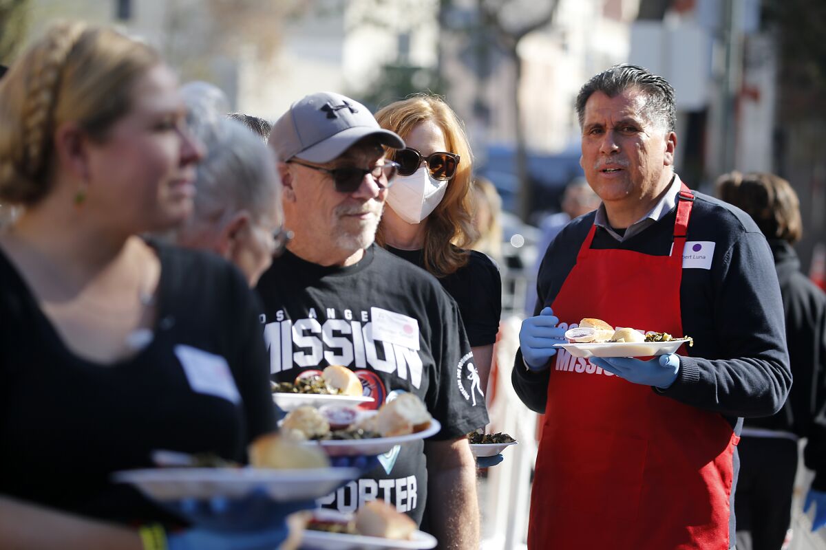 Robert Luna helps serve Thanksgiving dinner at the L.A. Mission.