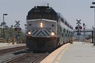 A northbound Coaster train arrives at the Poinsettia train station in Carlsbad.