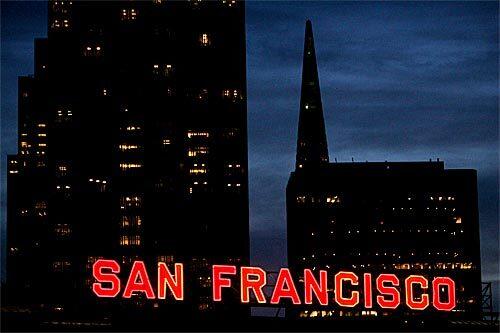 Thoughts of romance -- and weekend trips for valentines -- brings to mind San Francisco, a city with its share of romantic highlights. A neon sign lights up the city by the bay near the Ferry Building, with the Transamerica Pyramid in the background.