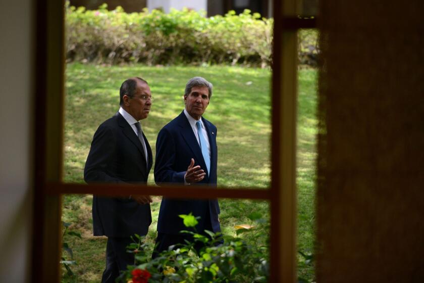 Secretary of State John Kerry, right, walks with Russian Foreign Minister Sergei Lavrov to a news conference at the Asia-Pacific Economic Cooperation summit in Nusa Dua on Indonesia's resort island of Bali.