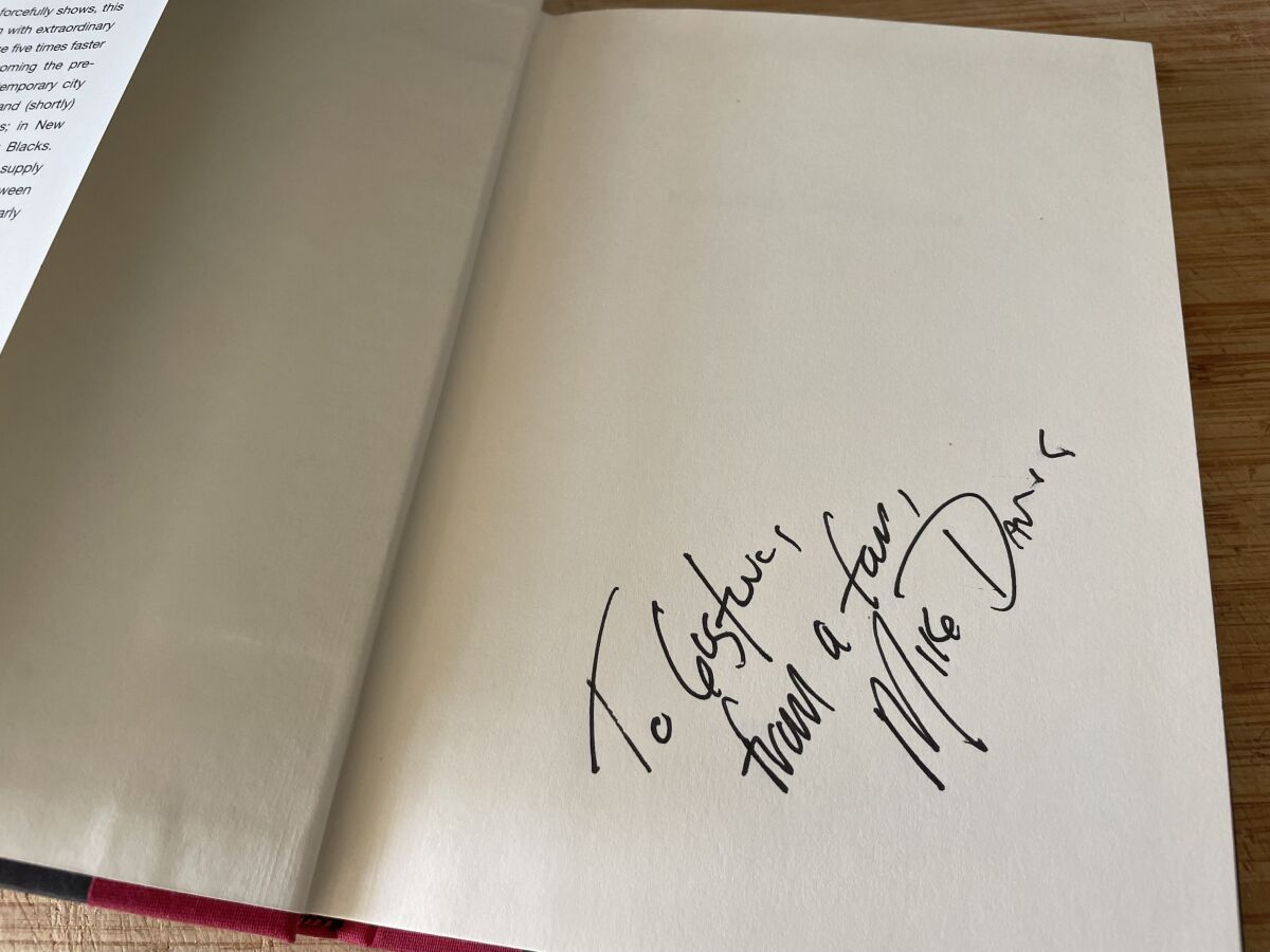 An inscription in a book reads, "To Gustavo, from a fan, Mike Davis"