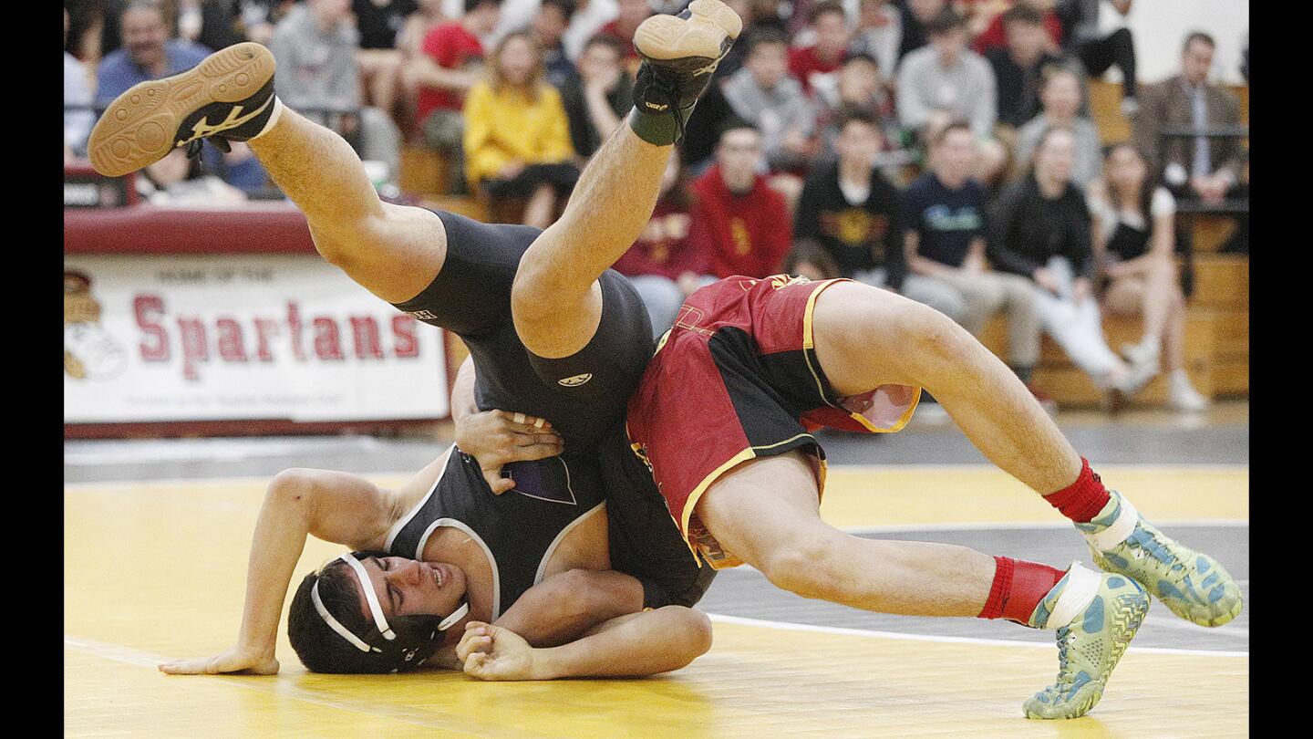 Hoover's Alex Shamiyan and La Canada's Brandon Abboud battle for leverage in a Rio Hondo League season finale wrestling match between rivals on Tuesday, January 30, 2018. La Canada's Abboud won the 138-pound bout. La Canada won and finished atop the Rio Hondo League for the second season in a row.