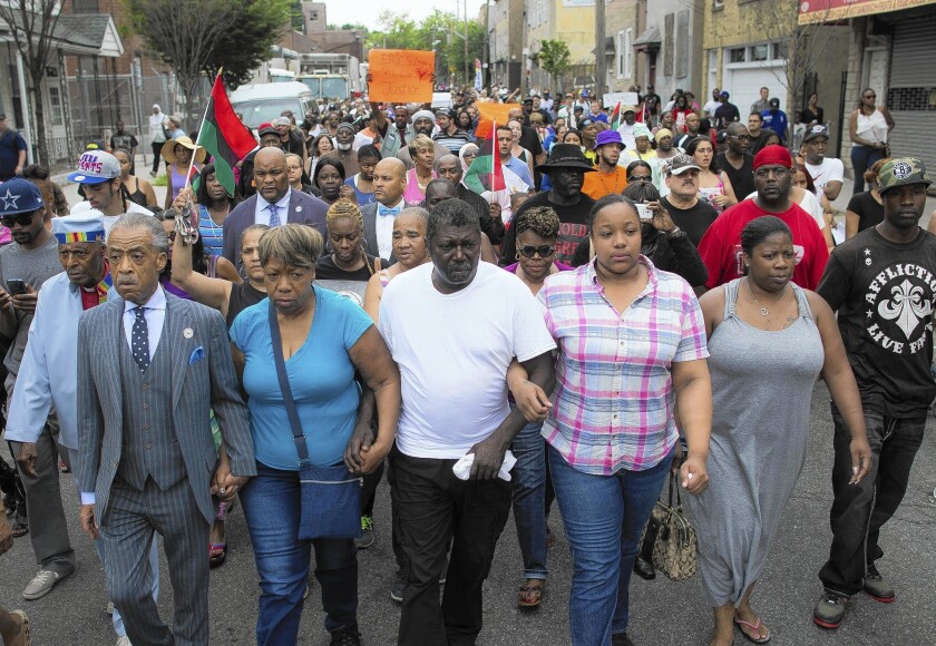 The Rev. Al Sharpton, left, and members of Eric Garner's family lead a march toward the site of Garner's fatal confrontation with New York City police. Police were trying to arrest Garner on suspicion of selling loose cigarettes on a Staten Island sidewalk, authorities said.