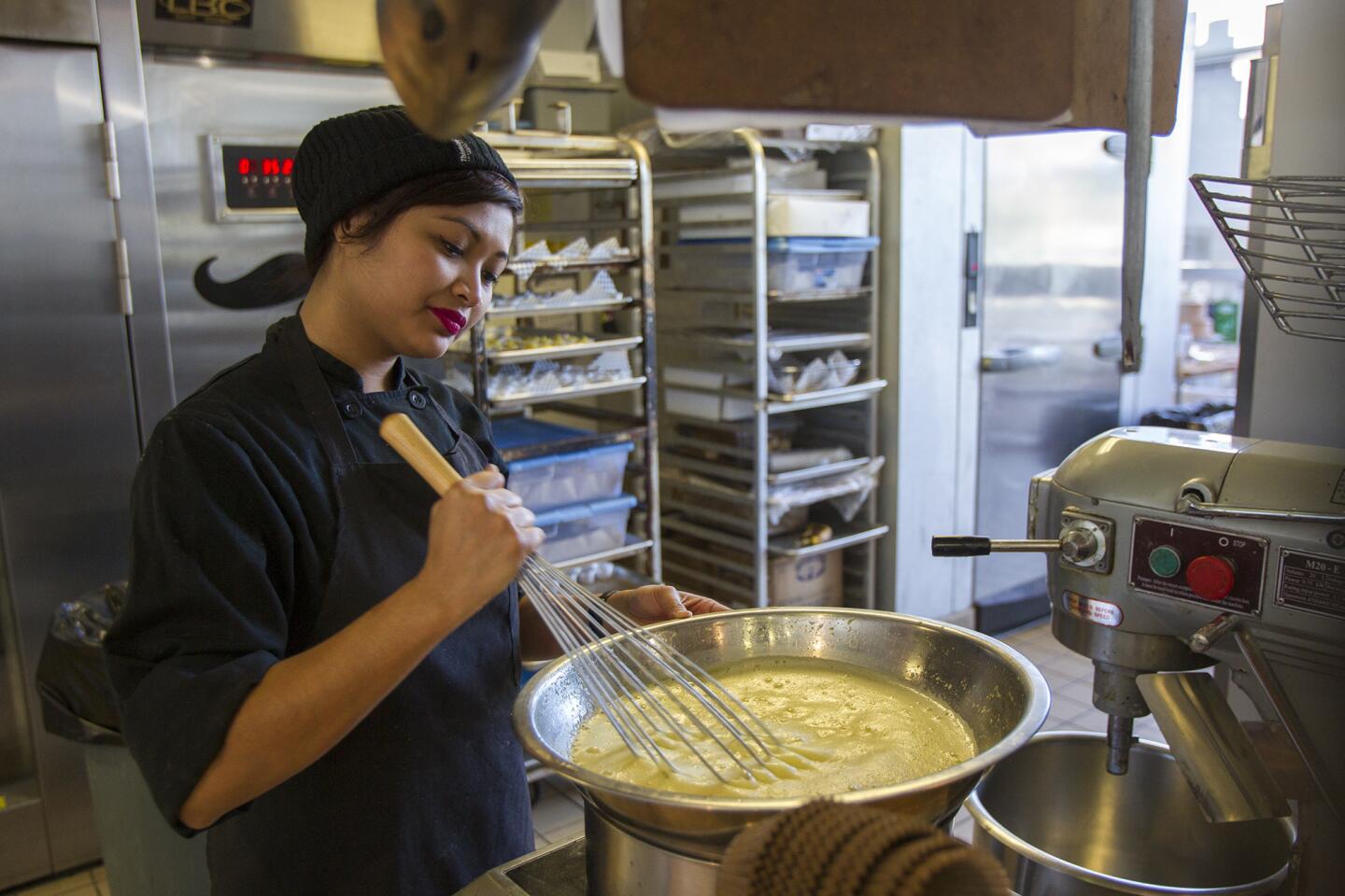 Denise Baquiran makes lemon curd at the Blackmarket Bakery during the one-year anniversary on Saturday, January 25. (Scott Smeltzer, Daily Pilot)