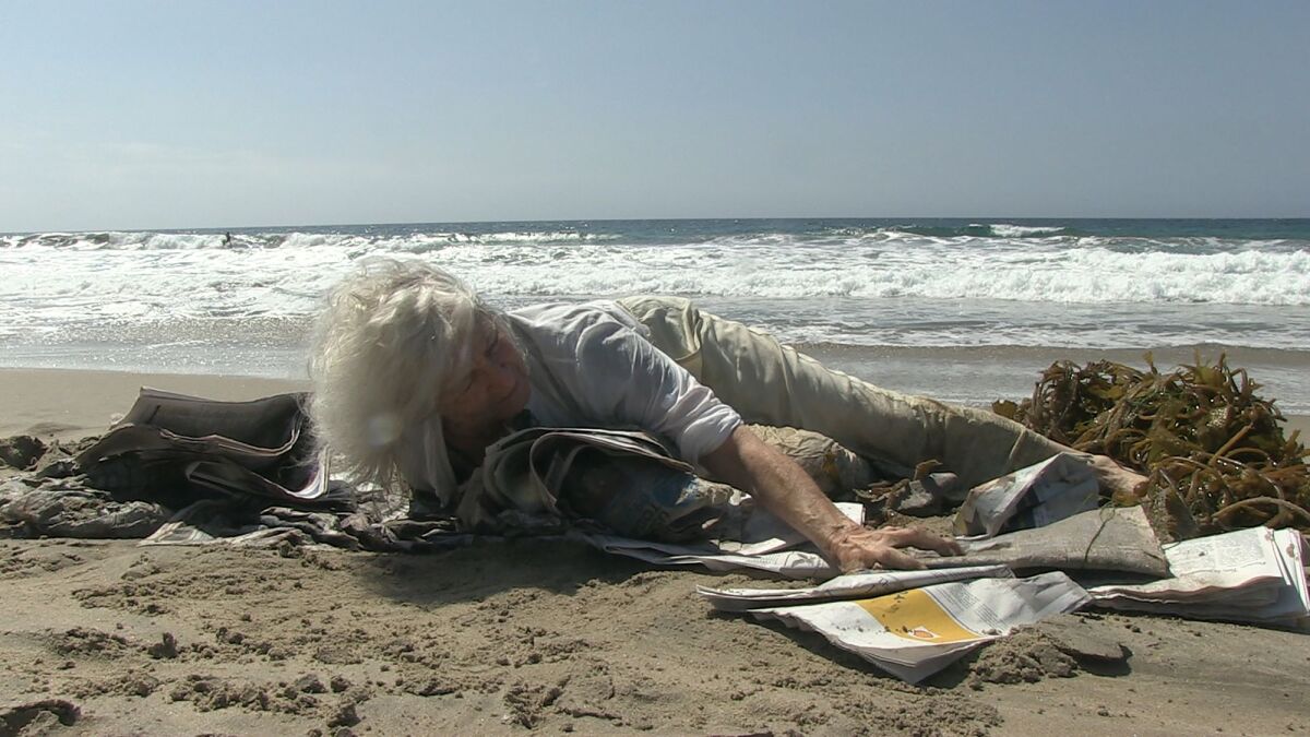 a woman lying on a beach 
