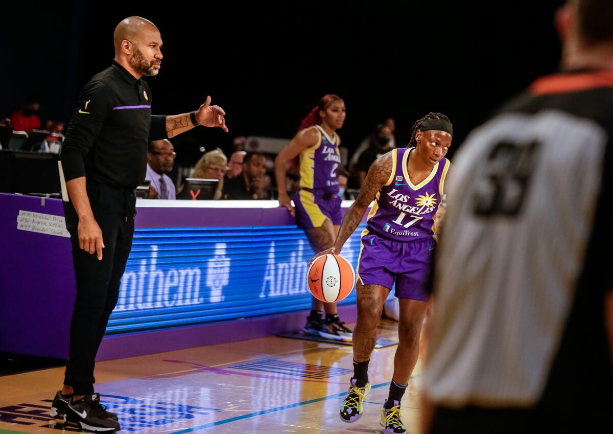 Sparks coach Derek Fisher watches as point guard Erica Wheeler runs a play.