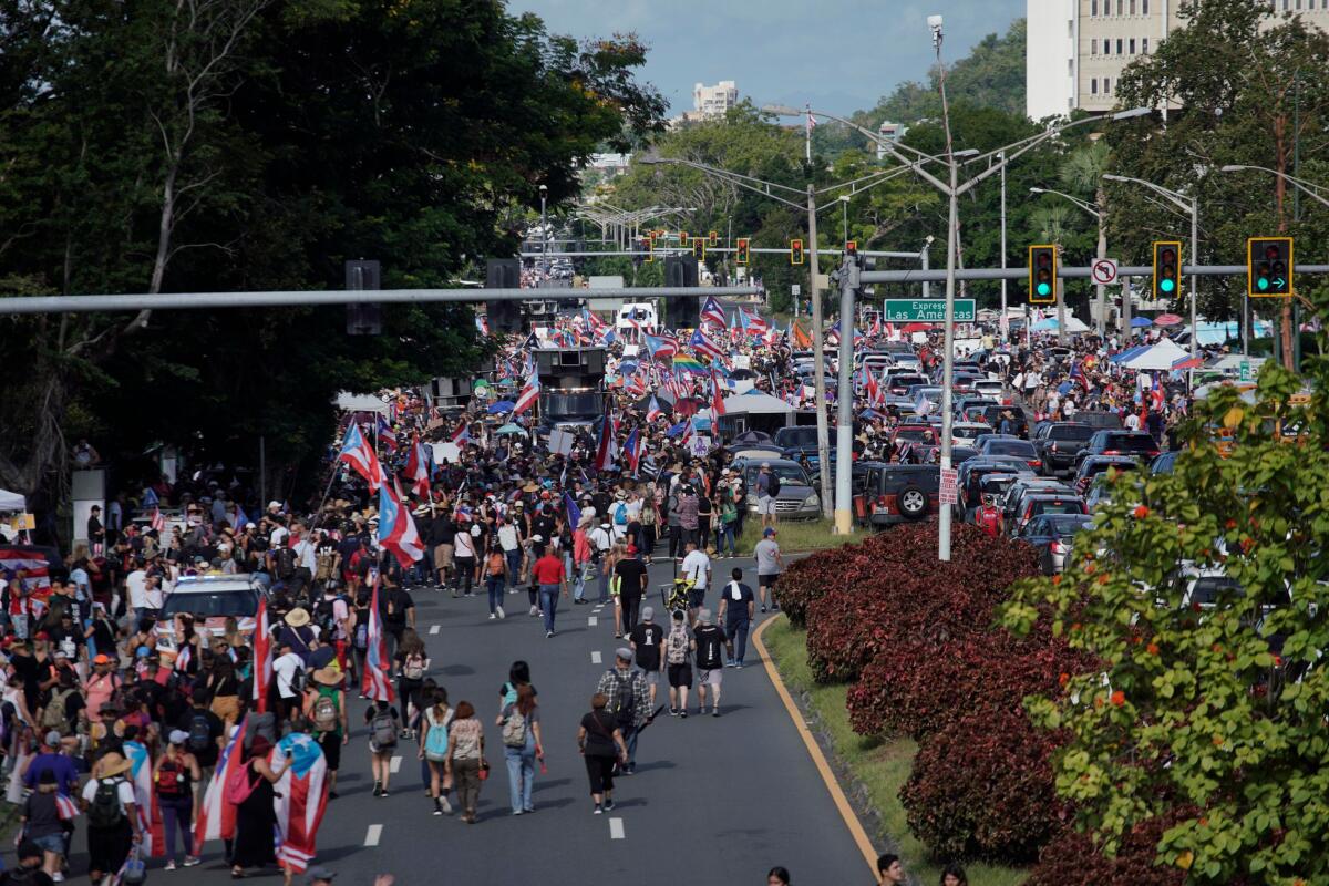 People take to the Las Americas Highway in San Juan, Puerto Rico, on the ninth day of continuous protests demanding the resignation of Gov. Ricardo Rossello.