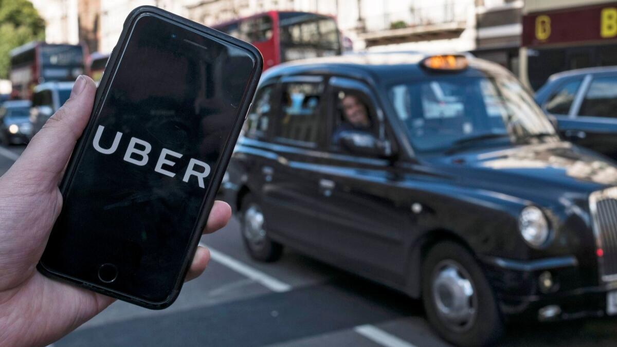 The Uber app on a mobile phone in central London