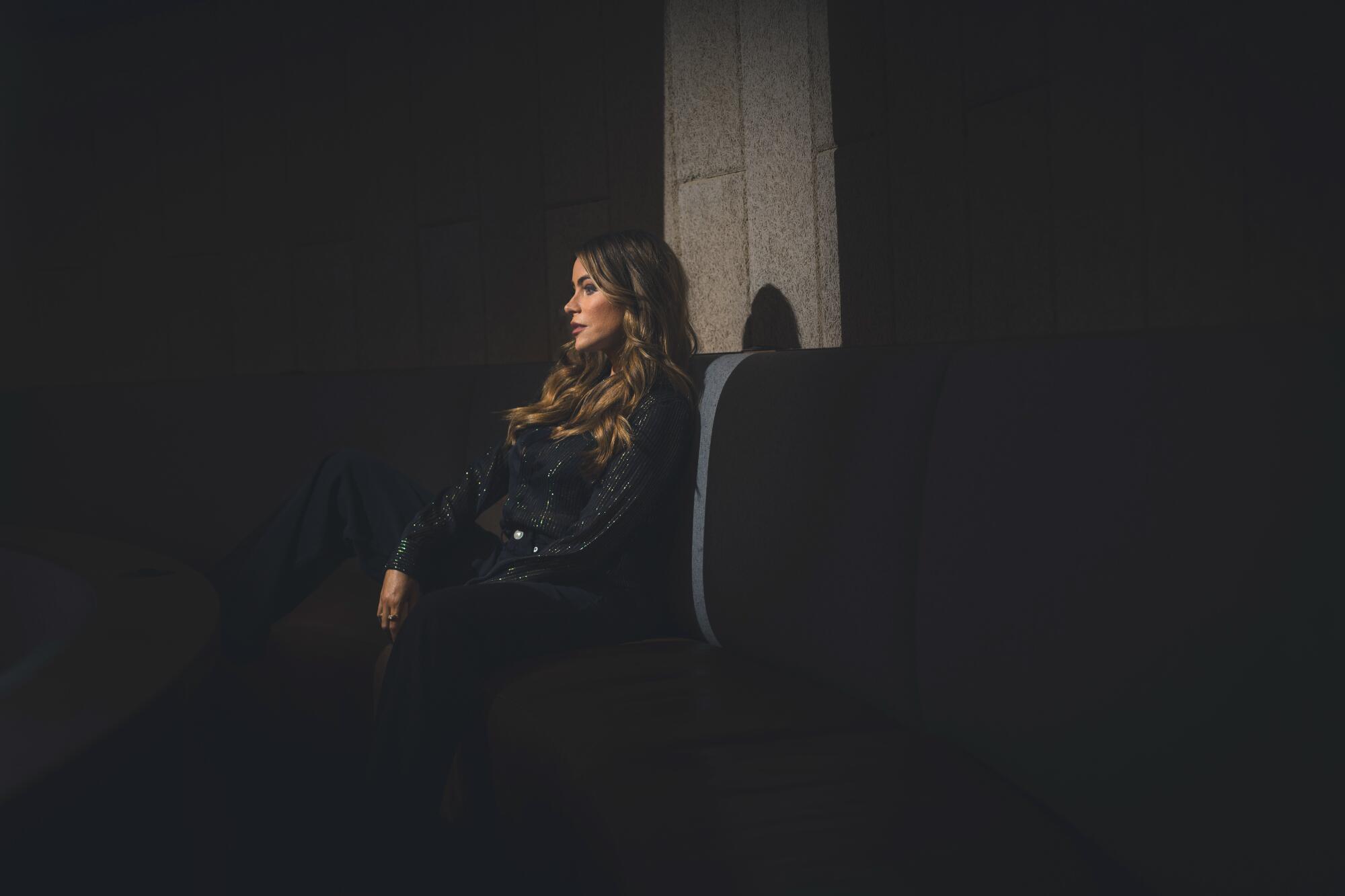 A profile photo of a woman sitting.