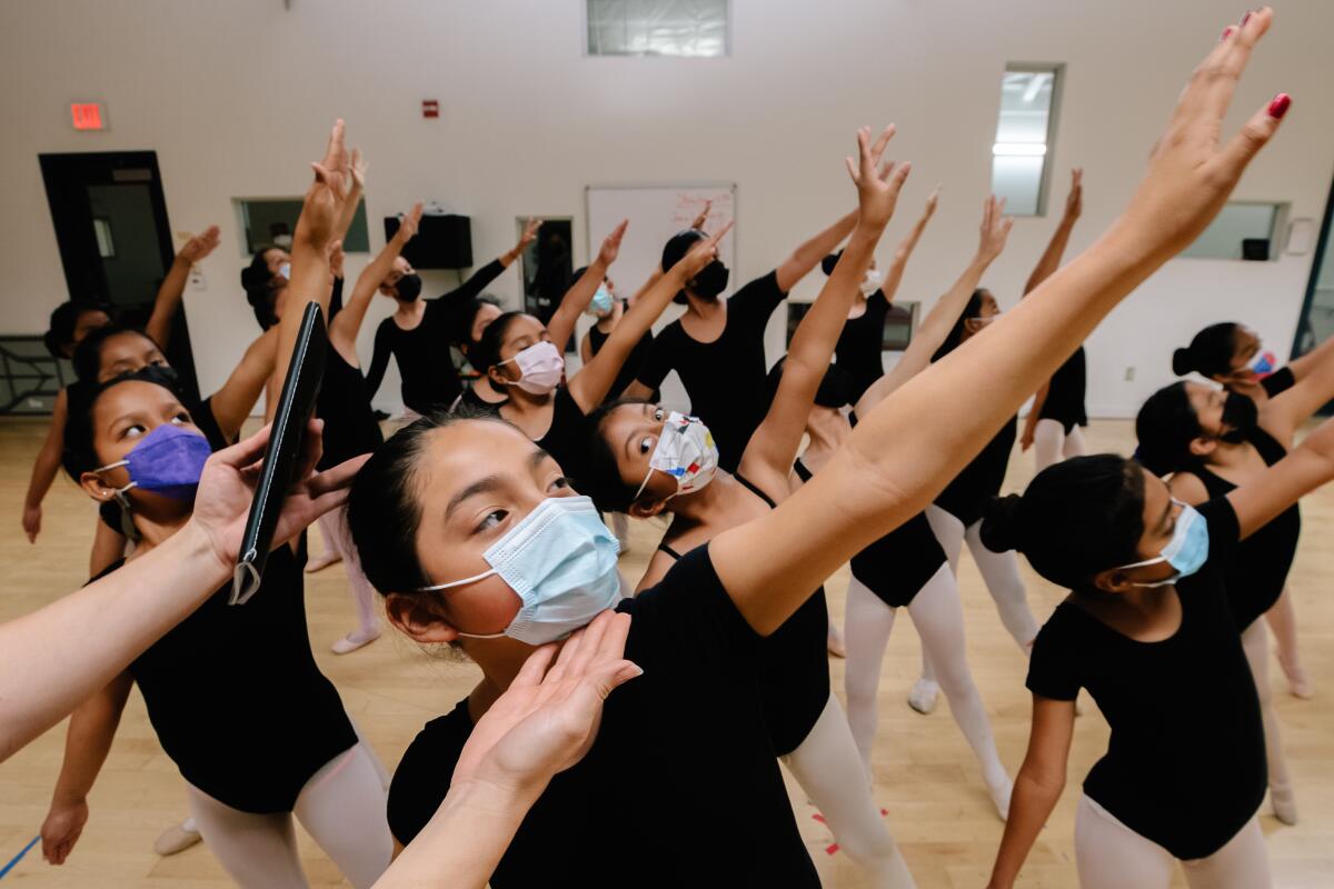 A group of girls dance ballet 