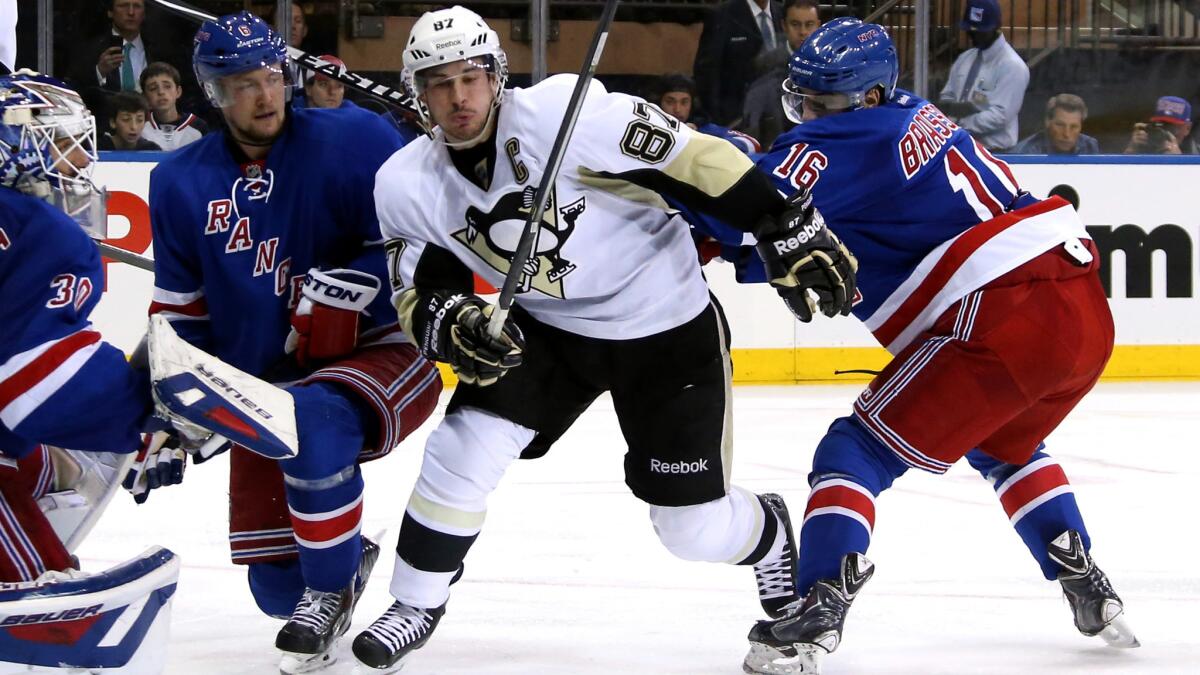 Pittsburgh Penguins captain Sidney Crosby, center, skates between New York Rangers teammates Derick Brassard, left, and Anton Stralman as goalie Henrik Lundqvist looks on during the Penguins' win in Game 4 of the Eastern Conference semifinals Wednesday.