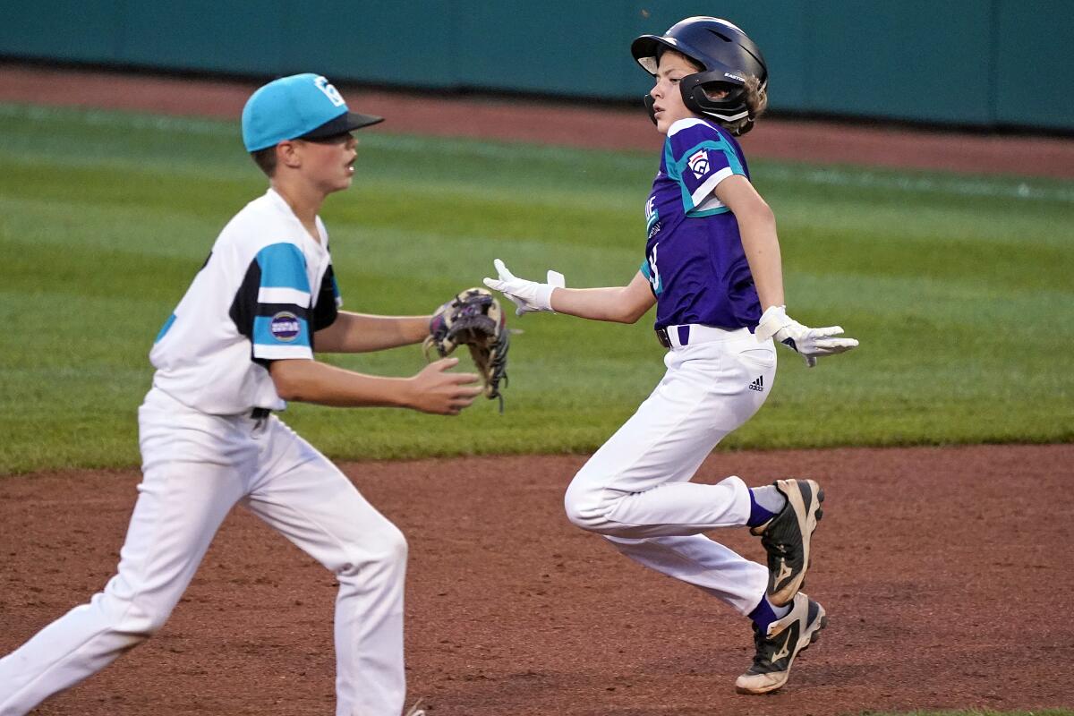 Ella Bruning gets ready to slide into second as Washington's Logan Rausch waits for the throw.