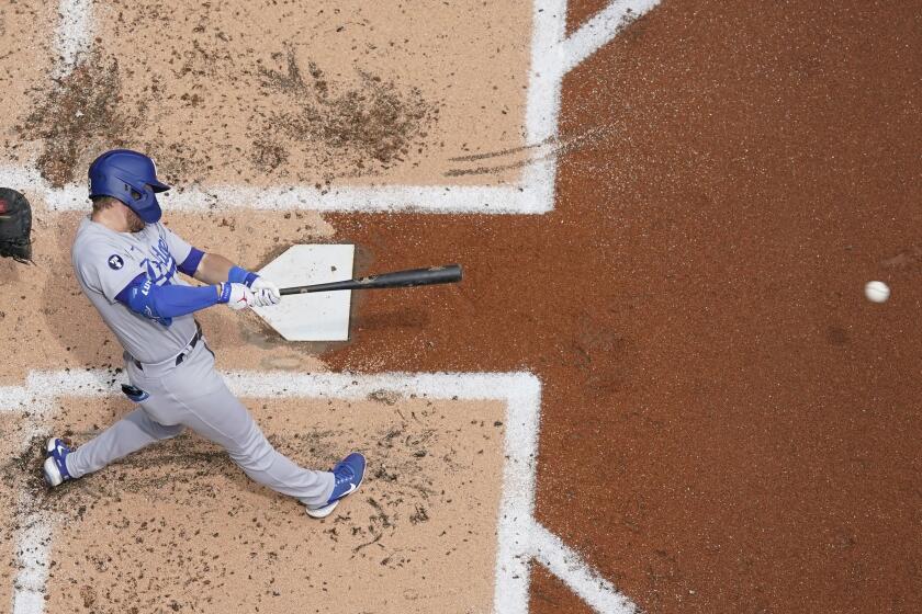 Los Angeles Dodgers' Gavin Lux hits a single during the second inning of a baseball game.