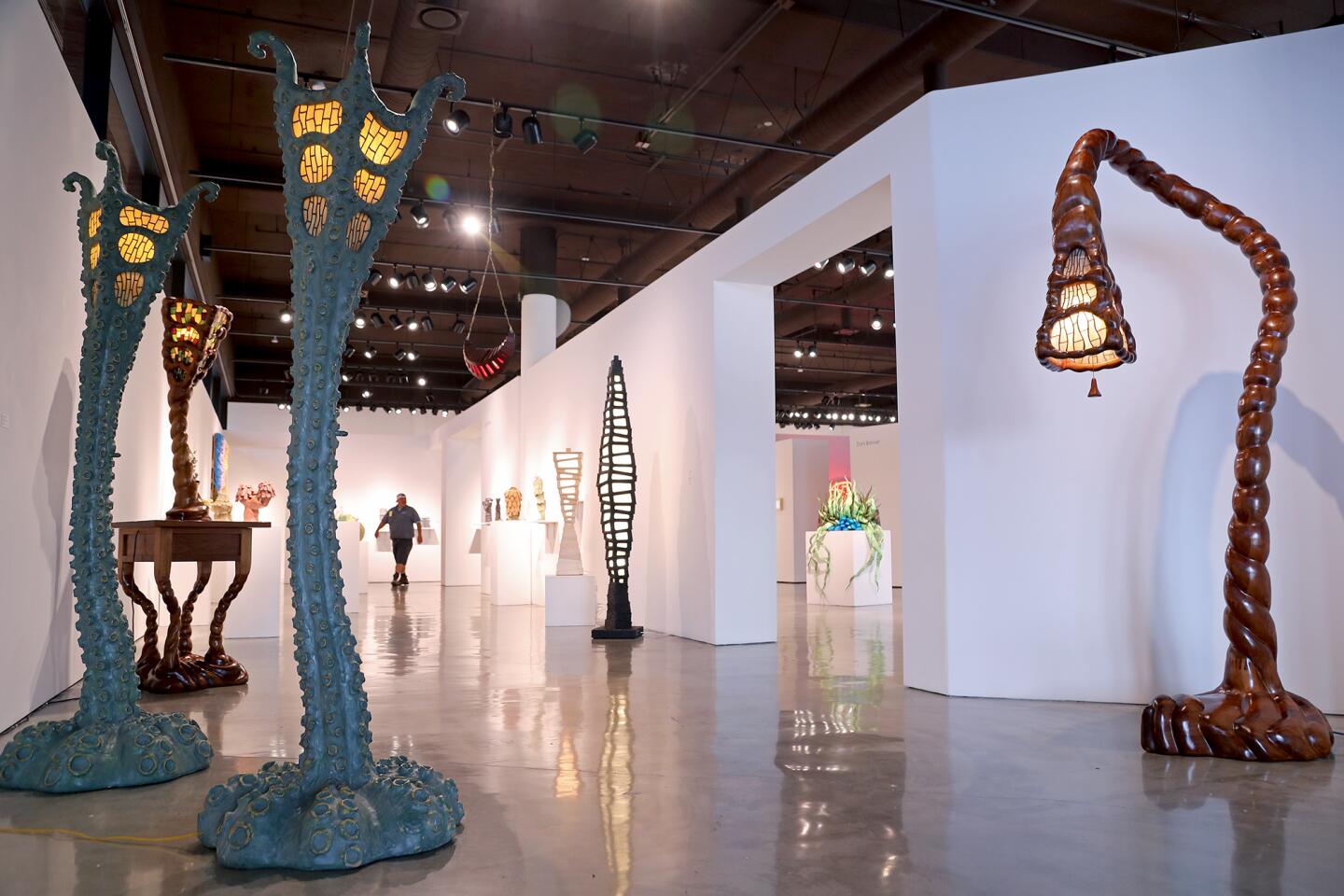 Octo Lamps, 2016, left, and Bent Lily Floor Lamp, 2007, far right, by Ashoke Chhabra.