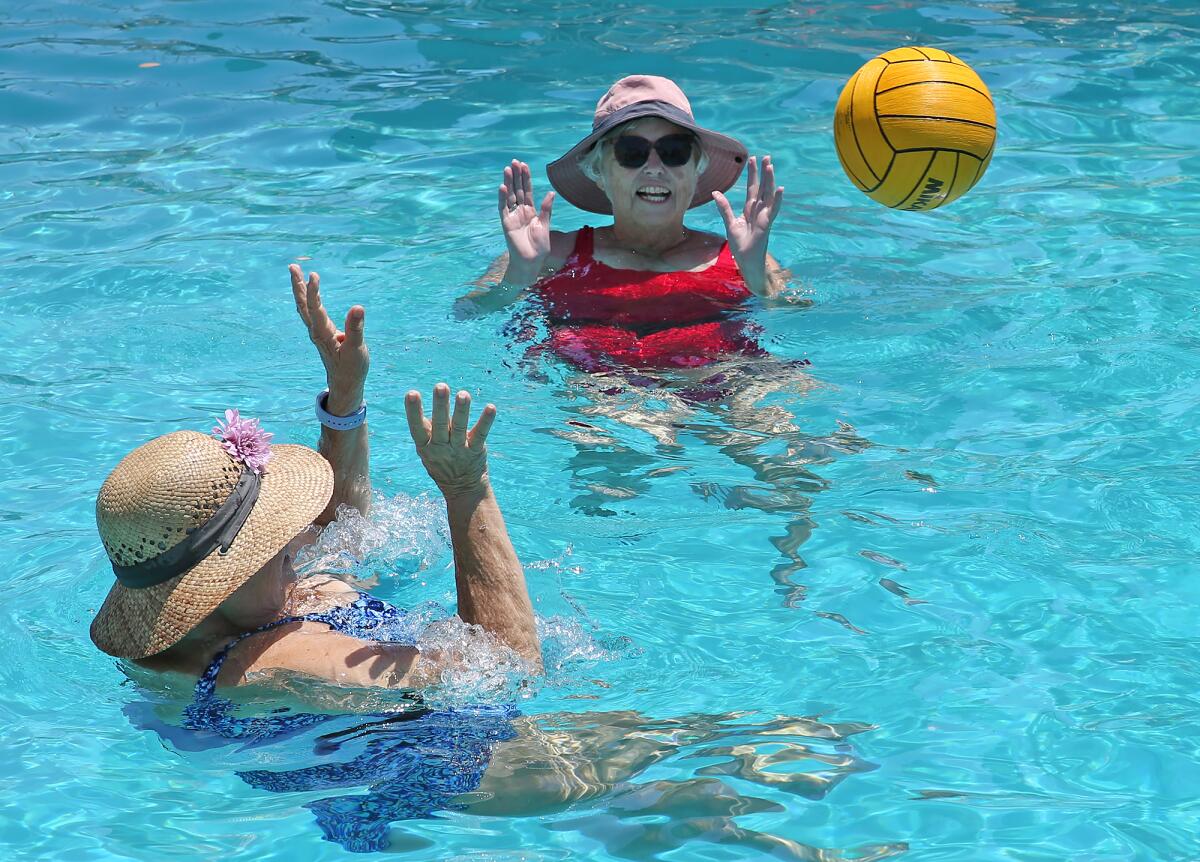 Mermaids play water polo during a Mermaid-a-Thon at the Newport-Mesa Family YMCA.