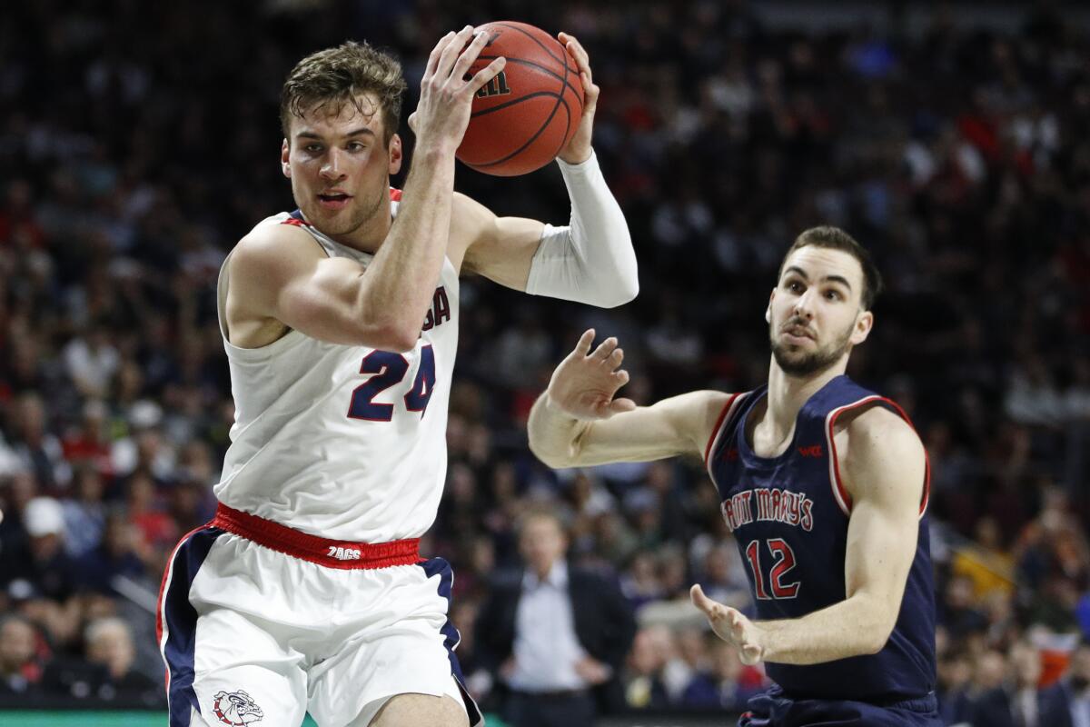 Gonzaga's Corey Kispert (24) drives around Saint Mary's Tommy Kuhse (12) in the first half of the West Coast Conference men's tournament final on Tuesday in Las Vegas.