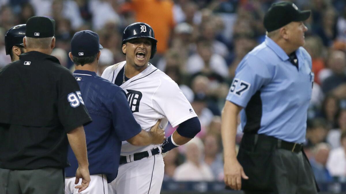 Tigers designated hitter Victor Martinez continues to yell at home plate umpire Mike Everitt (57) after getting ejected in the third inning Saturday.