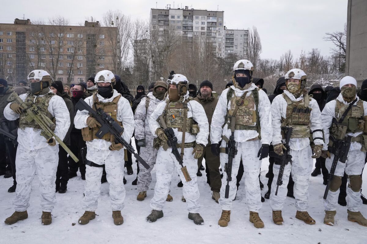 Ukrainians line up in military gear