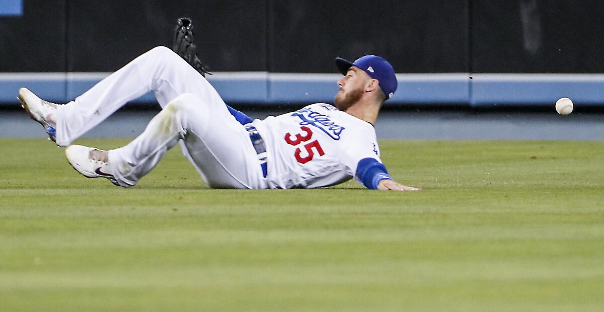 Dodgers center fielder Cody Bellinger slips as he tries to field a single by Colorado's Ryan McMahon on July 5, 2022.