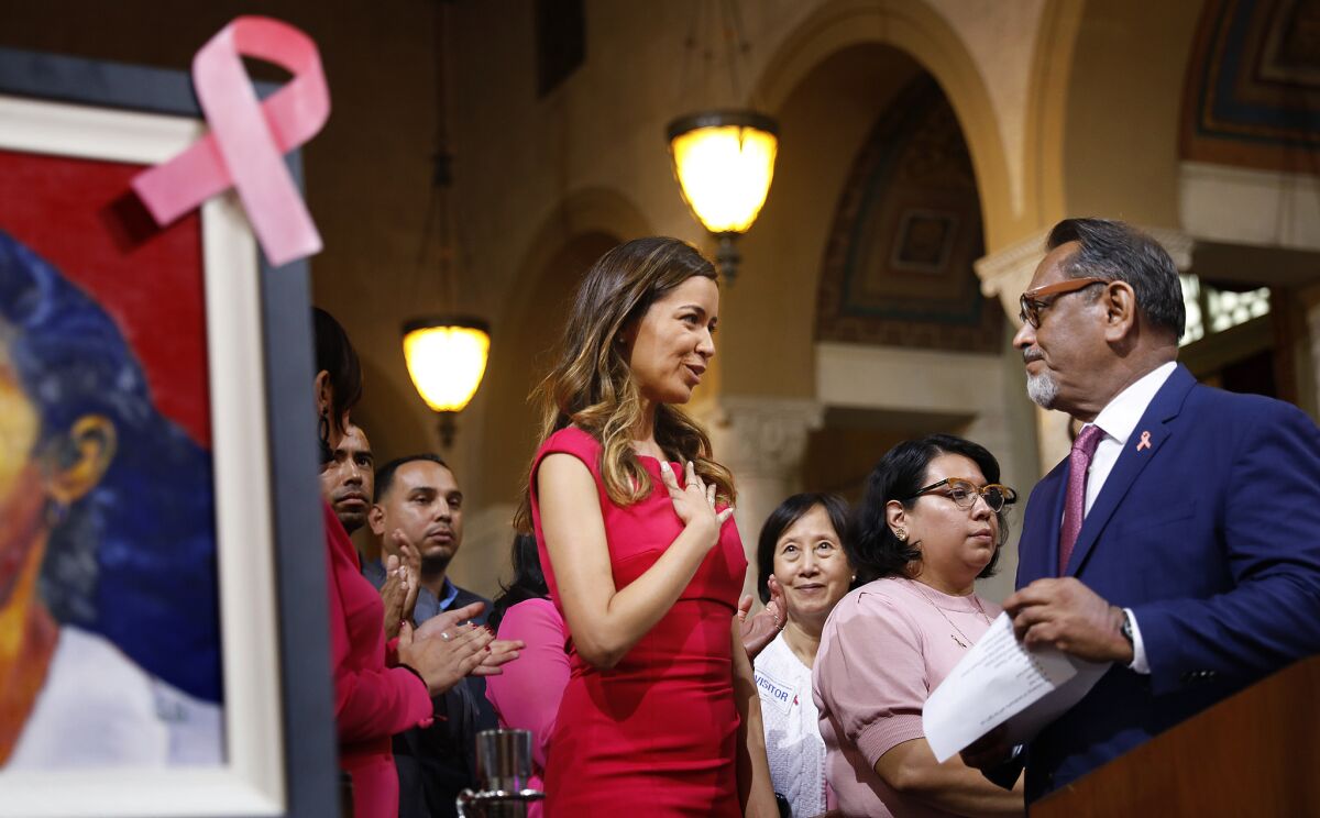Los Angeles City Councilman Gil Cedillo, right, introduces Alejandra Campoverdi during a presentation for Breast Cancer Awareness Month at Los Angeles City Hall in October.