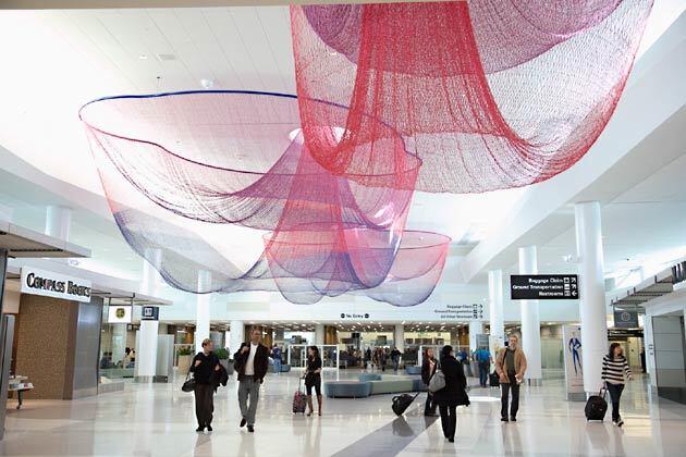 Janet Echelman's sculptural work, "Every Beating Second," hangs over the "recomposure" area of Terminal 2. The area is designed to give travelers a comfortable place to compose themselves after passing through TSA security checkpoints.