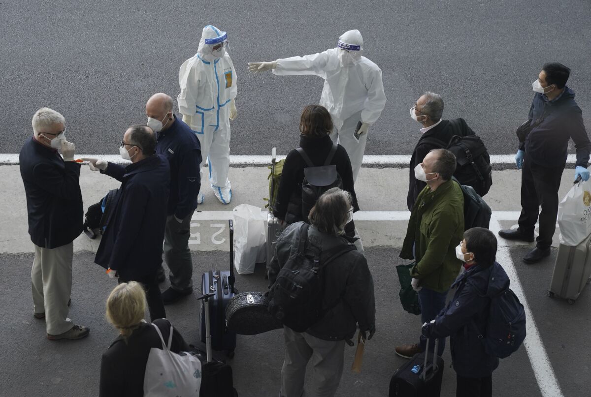 Members of a World Health Organization team arrive in Wuhan, China, to investigate the coronavirus' origins.