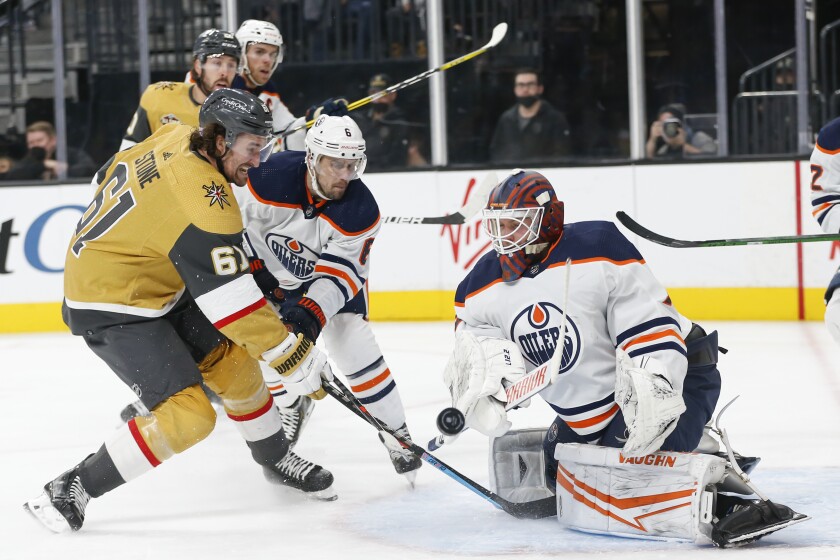 Vegas Golden Knights right wing Mark Stone (61) attempts to get a rebound shot past Edmonton Oilers goaltender Mikko Koskinen (19) during the second period of an NHL hockey game Saturday, Nov. 27, 2021, in Las Vegas. (AP Photo/Chase Stevens)