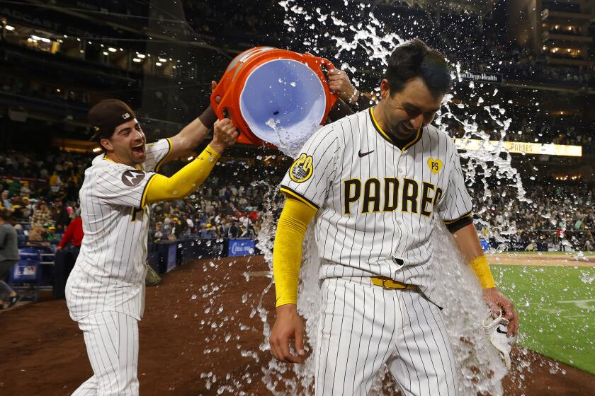 San Diego, CA - June 11: San Diego Padres' Kyle Higashioka gets dunked after hitting a walk off home run to beat the Oakland Athletics 4-3 at Petco Park on Tuesday, June 11, 2024. (K.C. Alfred / The San Diego Union-Tribune)