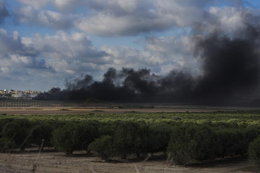 Smoke rises from tires set ablaze by Palestinian demonstrators during a protest along the frontier between Gaza and Israel, as seen from the Israeli side of the fence, Saturday, Sept. 23, 2023. (AP Photo/Tsafrir Abayov)