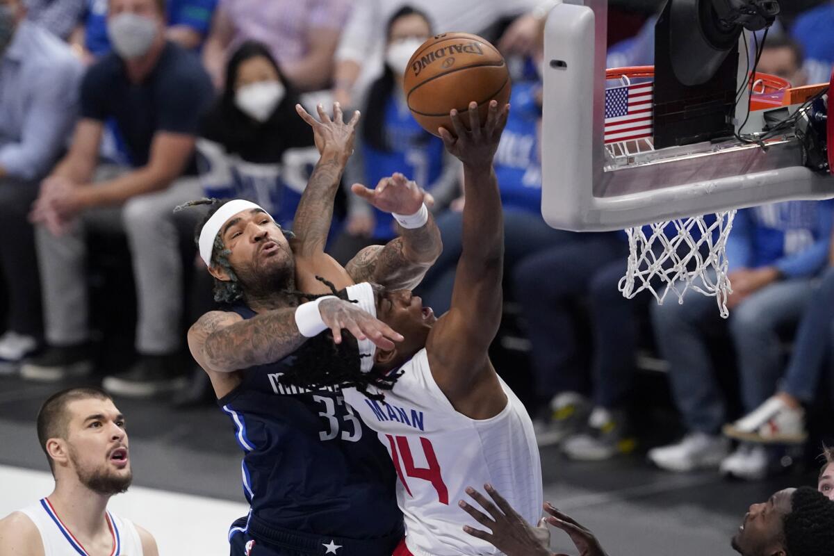 Clippers guard Terance Mann is fouled at the net.