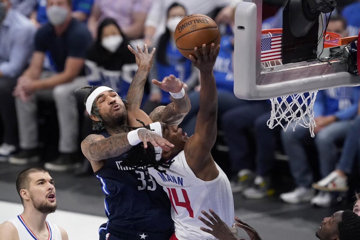 Clippers guard Terance Mann is fouled at the net.