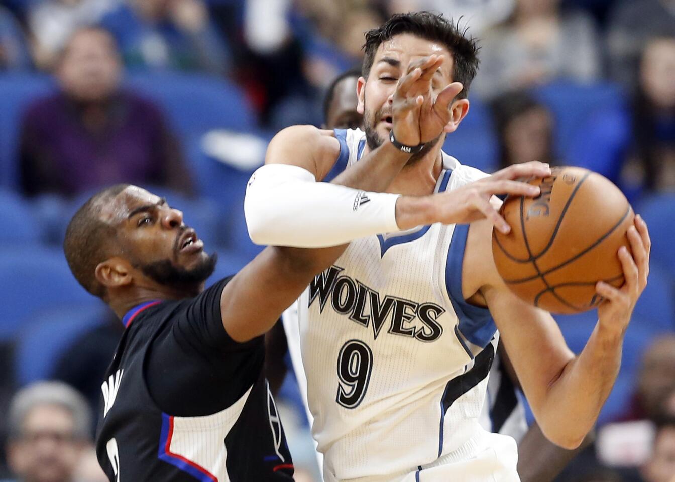 Clippers point guard Chris Paul tries to steal the ball from Timberwolves point guard Ricky Rubio during the first half.
