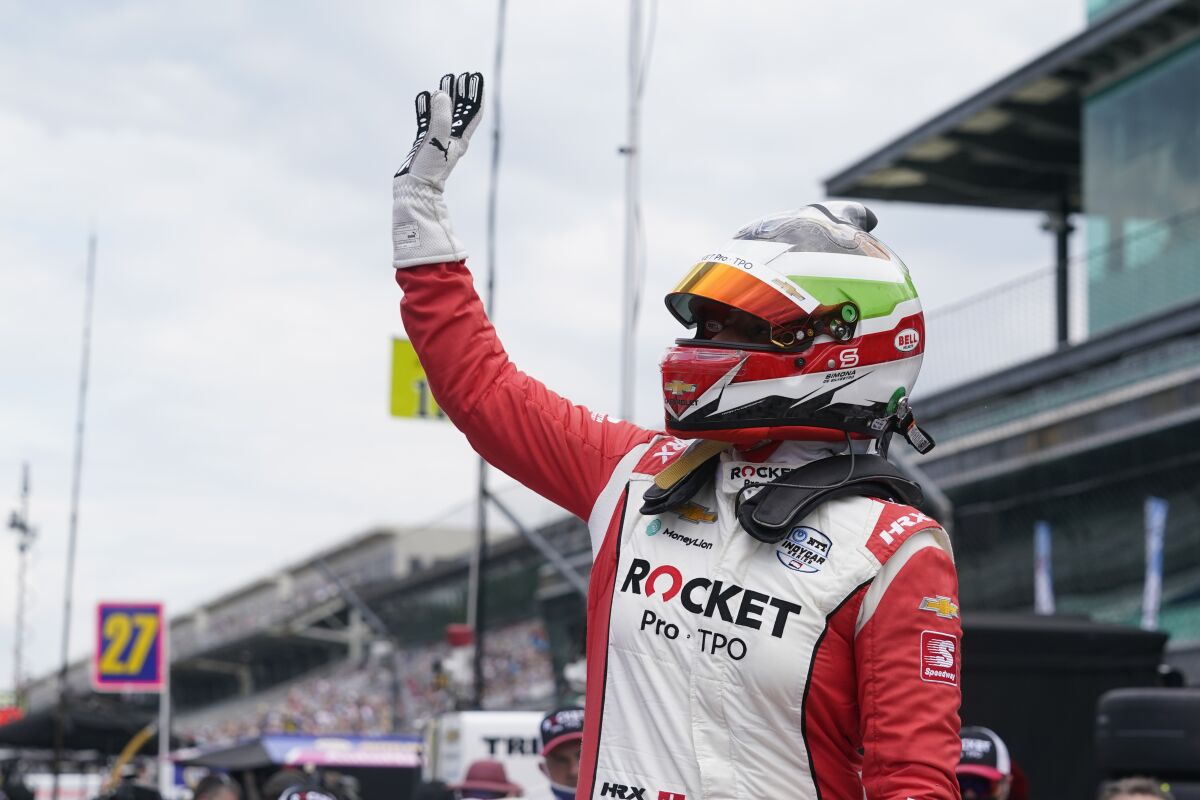 FILE - Simona de Silvestro, of Switzerland, waves to fans during qualifications for the Indianapolis 500 auto race at Indianapolis Motor Speedway on May 23, 2021, in Indianapolis. de Silvestro will make her IndyCar season debut Sunday, June 12, 2022, at Road America, joining Tatiana Calderon in the field to give IndyCar two women entering multiple events for the first time since 2013. (AP Photo/Darron Cummings, File)