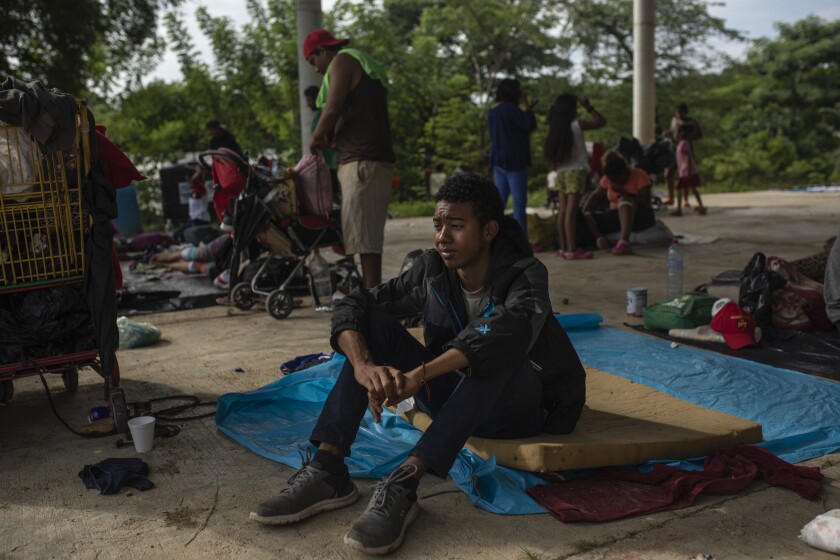 A Honduran teen fleeing the violence and corruption in his country sits in a school patio in the Mexican state of Veracruz