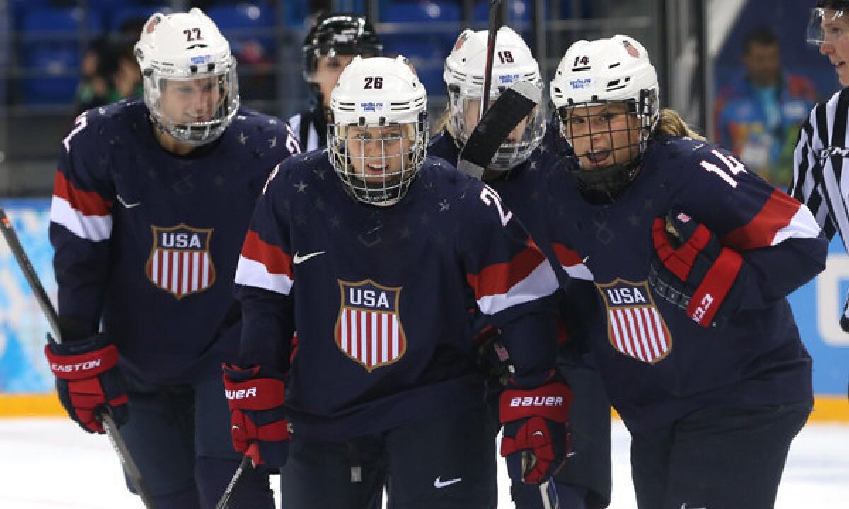American Brianna Decker, far right, celebrates with teammates (from left to right) Kacey Bellamy, Kendall Coyne, and Gigi Marvin after scoring a goal during Team USA's 6-1 semifinal win over Sweden at the Sochi Winter Olympic Games on Monday.