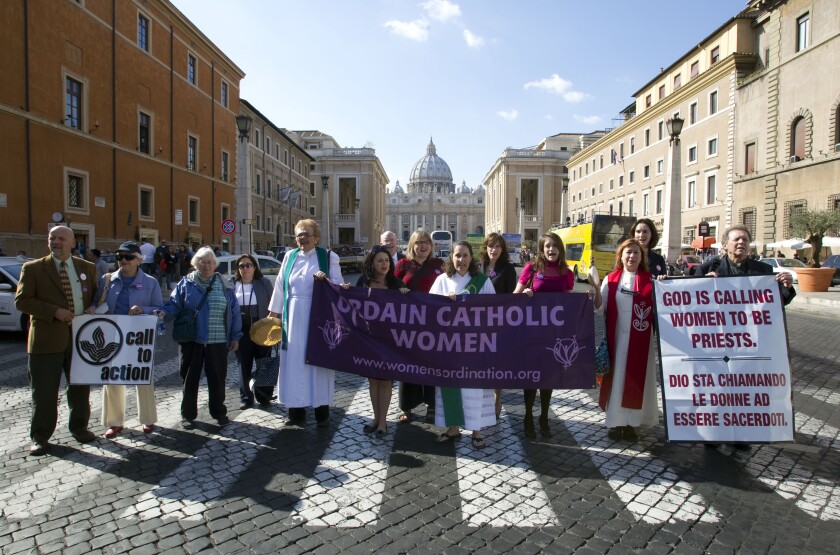 Members of the Women's Ordination Conference group stage a protest in front of St. Peter's Basilica, in Rome, on Oct. 17, 2011. The Vatican has included a group that advocates for women’s ordination on a website promoting its two-year consultation of rank-and-file Catholics in the latest sign that Pope Francis wants to hear from all Catholics during the process. The Women’s Ordination Conference has launched a “Let Her Voice Carry” campaign in conjunction with the Vatican’s 2023 “synod” or gathering of the world’s bishops. In the run-up to the meeting, the Vatican has asked dioceses, religious orders and other Catholic groups to embark on listening sessions to hear from ordinary Catholics about their needs. (AP Photo/Andrew Medichini, File)