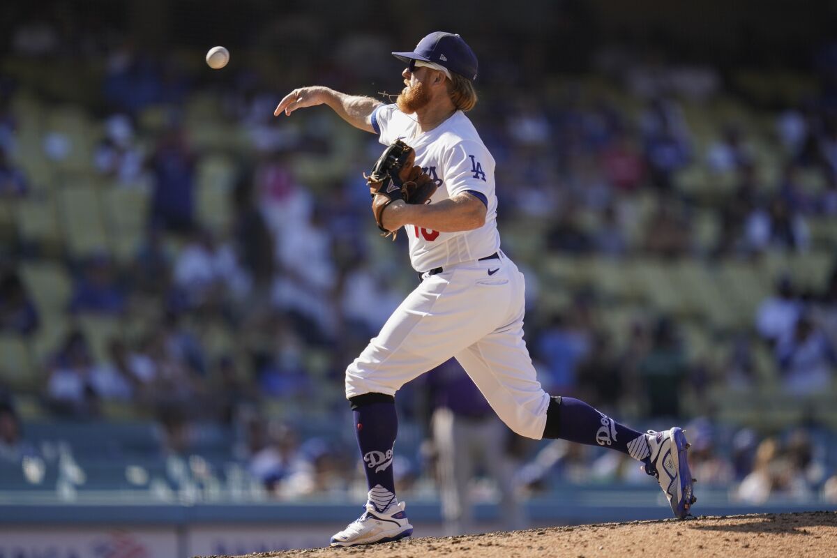 Justin Turner delivers a pitch in the ninth inning of the Dodgers' 5-0 loss.