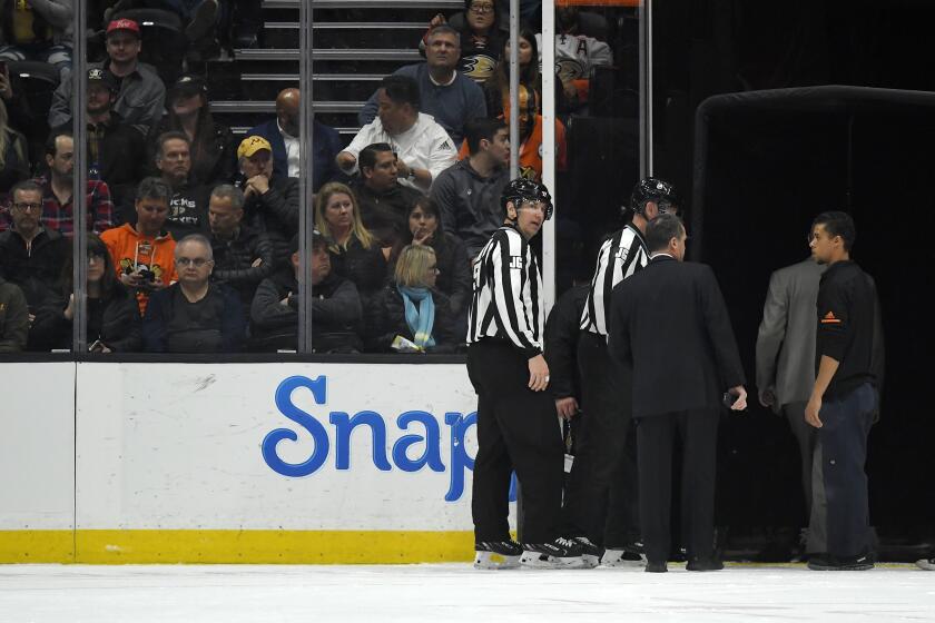Officials leave the ice after the game between the Anaheim Ducks and the St. Louis Blues was postponed following a medical emergency involving Blues defenseman Jay Bouwmeester during the first period of an NHL hockey game Tuesday, Feb. 11, 2020, in Anaheim, Calif. (AP Photo/Mark J. Terrill)